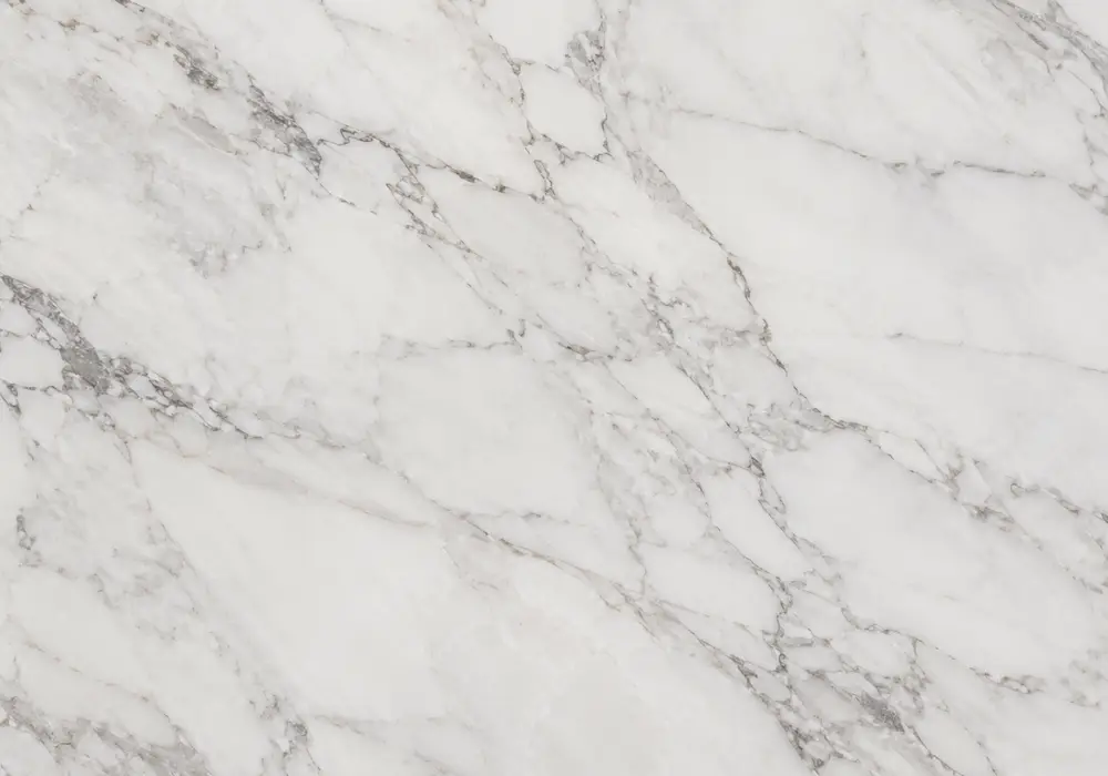 Indian white marble UAE on flooring, island and stairs with milky white stone, irregular grey-brown marks and grade shifts.
