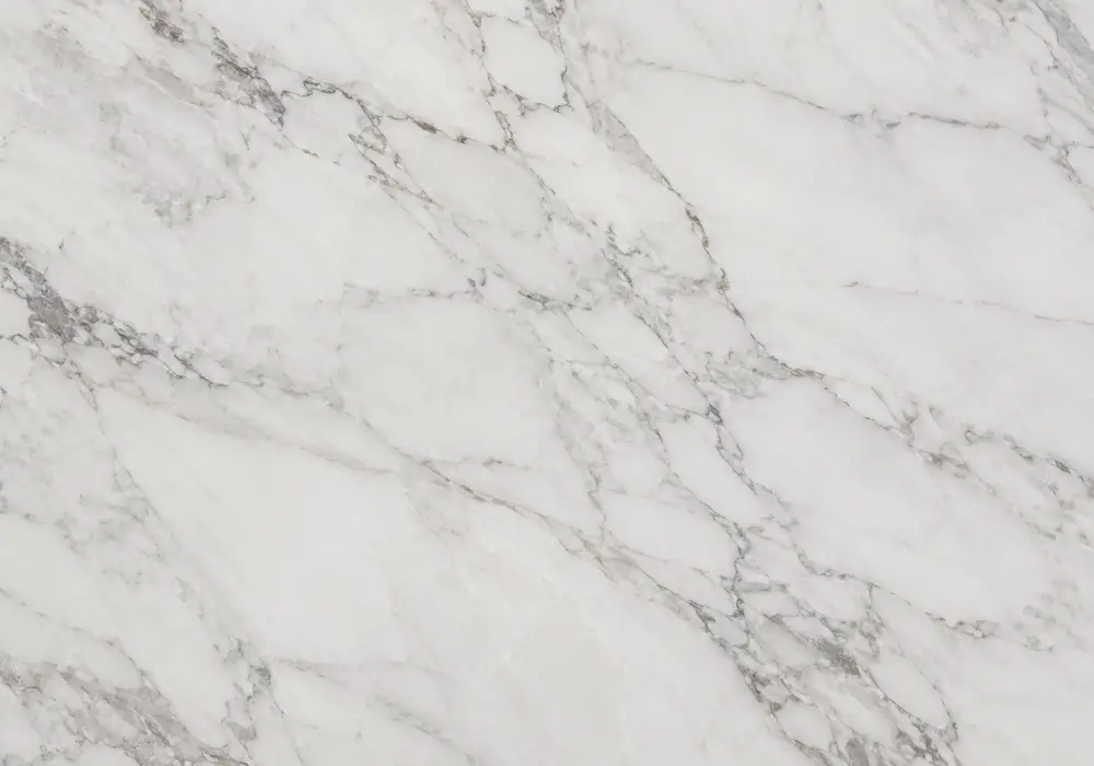 Vagli marble kitchen with island and bookmatched backsplash, showing white stone with looping anthracite arabesque veins.
