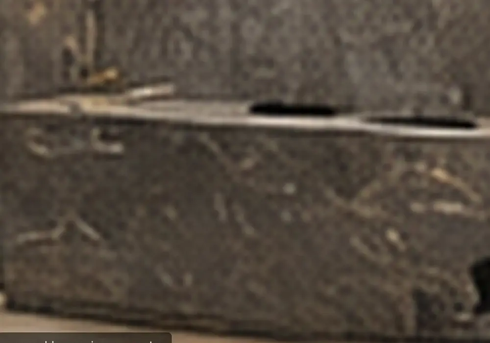 honed grey marble finish across a reception desk, stairs, fireplace and bathroom surfaces with restrained silver-white veins.