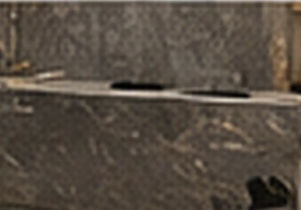 Fine silver veins cross a dark charcoal-grey background, creating a composed marble surface with crisp natural mineral depth.