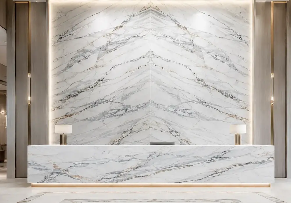 gold-vein Lasa marble on refined exterior facade and monument with polished and honed Alpine-white slab samples in daylight.