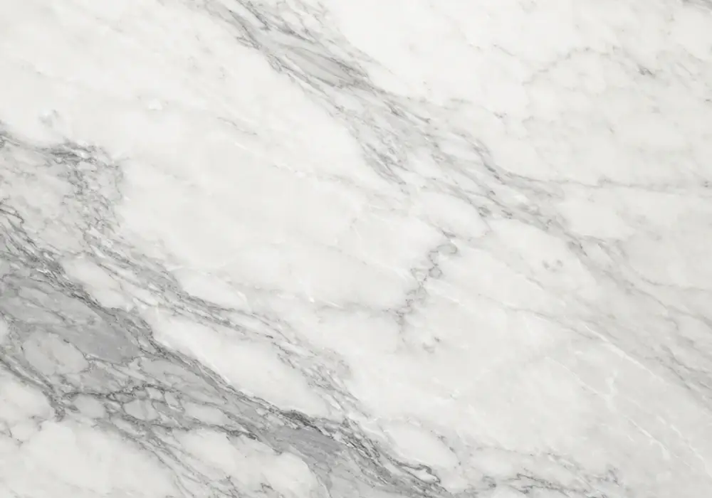 Bianco Venato marble dining table with cool white stone and flowing medium-grey to charcoal veining.