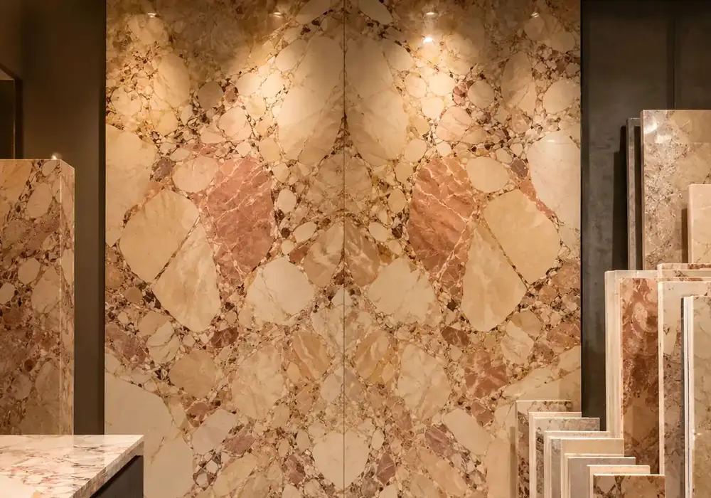 Blush, ivory and terracotta fragments shape Breccia Aurora Marble, showcasing expressive Italian brecciated marble beauty.