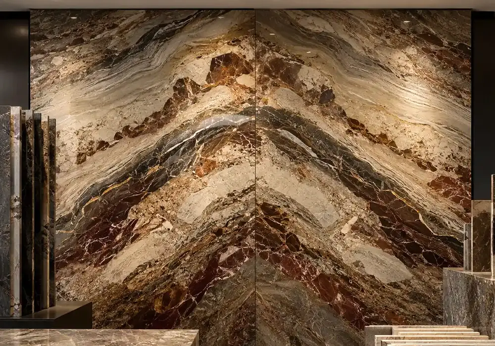 Breche Fantastique Marble bookmatched reception wall with terracotta, gold and cream brecciated patterns.