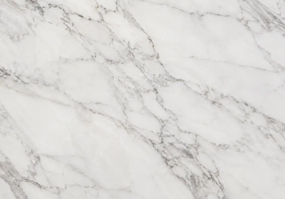 Pietra Grey marble on polished kitchen counter, vanity and honed bathroom floor in layered grey with soft white veins nearby.