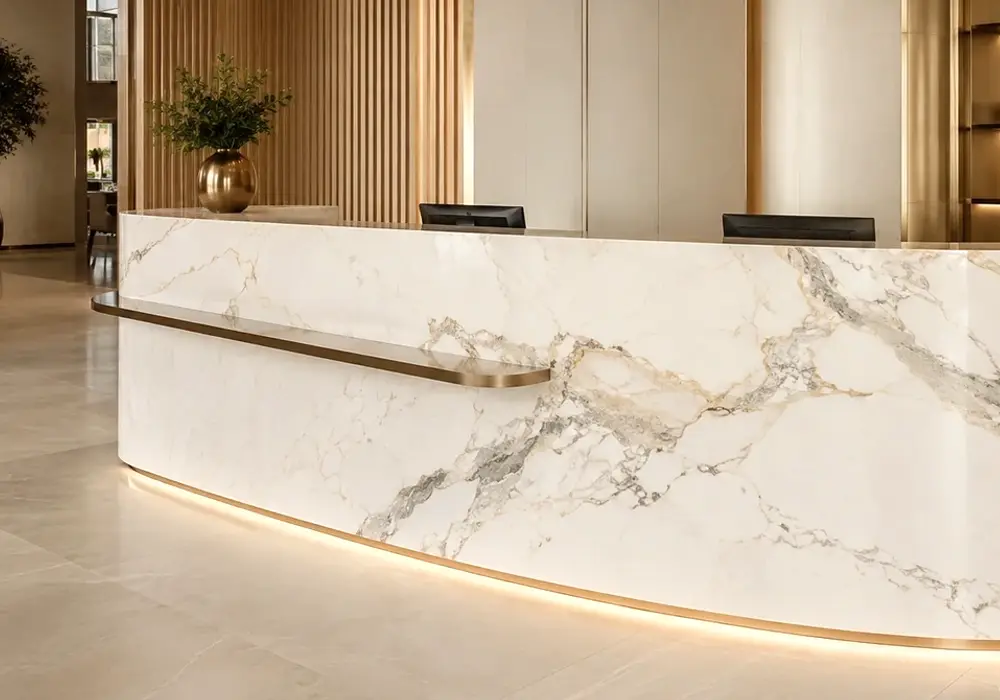 Calacatta Caldia marble dining table with warm ivory stone and soft graphite, grey and muted-gold veining.
