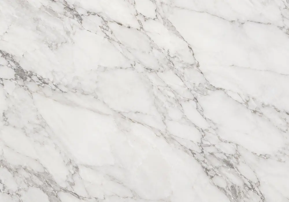 Calacatta Cremo bathroom with polished vanity and wall panel, plus exterior sample in creamy stone with warm grey-gold veins.