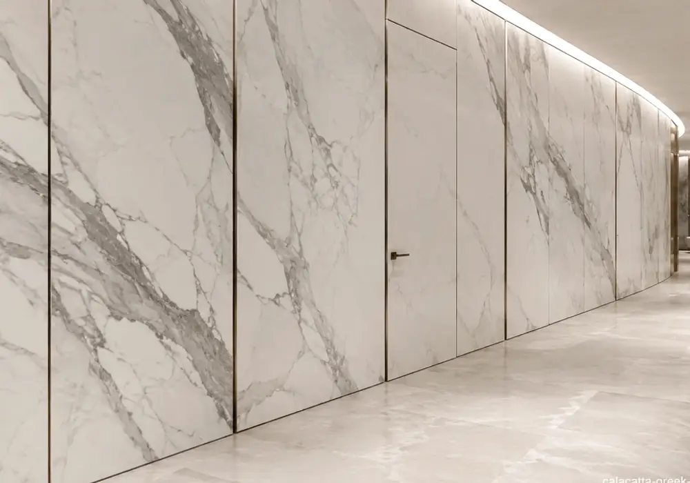 Grey, beige and gold streams cross Calacatta Greek Marble, presenting a refined Greek white marble selection stone surface.