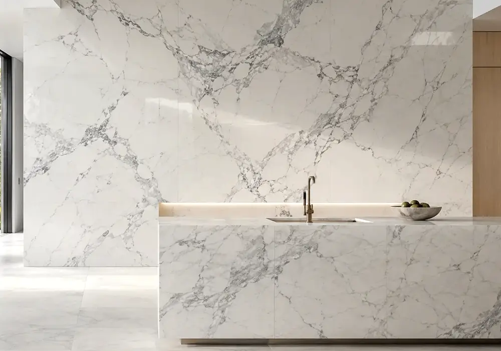 Statuario Lincoln marble on polished kitchen island, vanity and feature wall, showing warm white stone with silver veins.