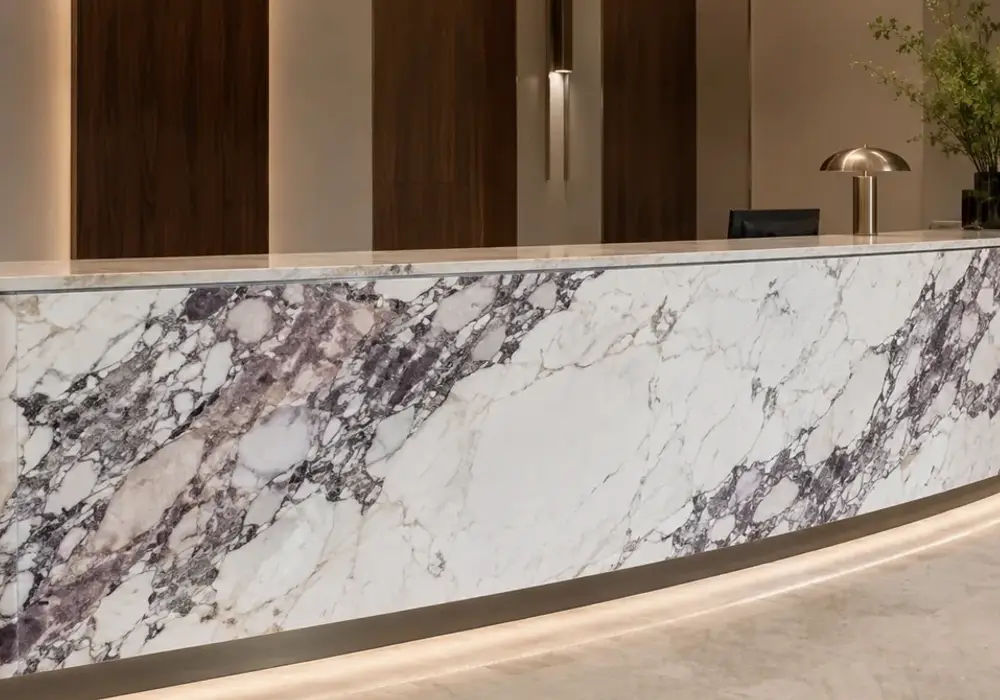 Calacatta Viola Marble fireplace surround in a luxury stone showroom with upright slabs and refined wall finishes