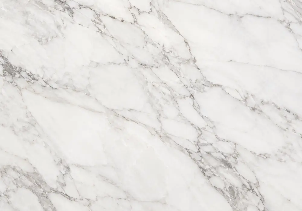 Calacatta Gold variety used across slabs, flooring, stairs, fireplace, table and sink with deliberate aligned vein layout.