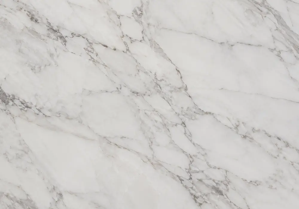 Calcutta Marble dining tabletop in a luxury stone gallery with upright slabs and refined architectural finishes