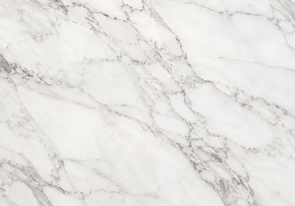 Calacatta White stone in a luxury kitchen, showing authentic veining, refined stone texture and balanced interior lighting.