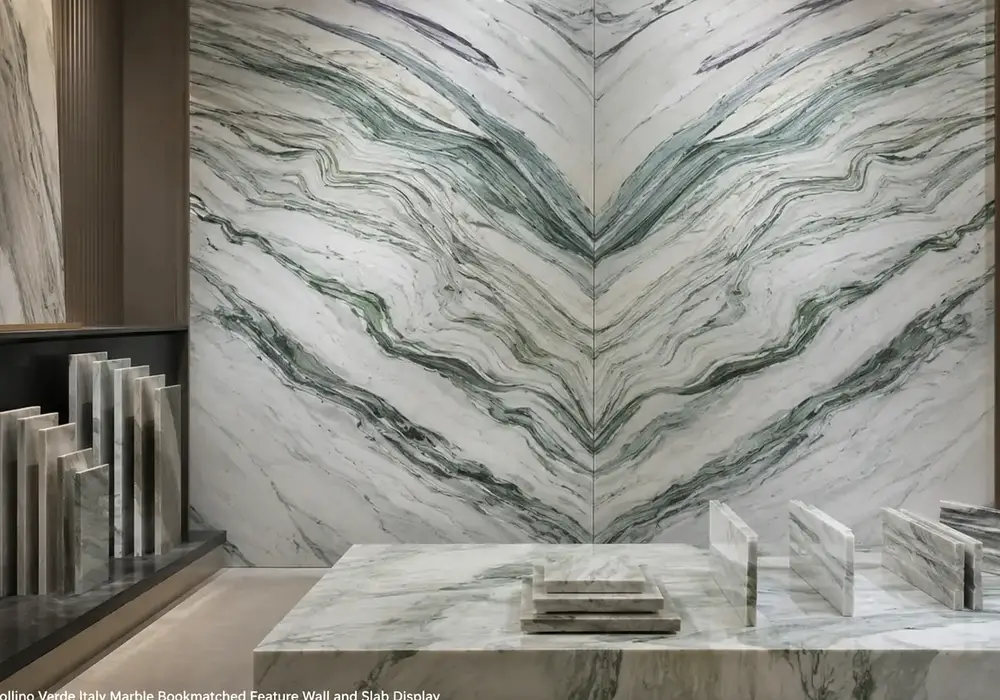 Cipollino Verde marble foyer feature wall with pale sage-grey stone and distinctive flowing green veins.