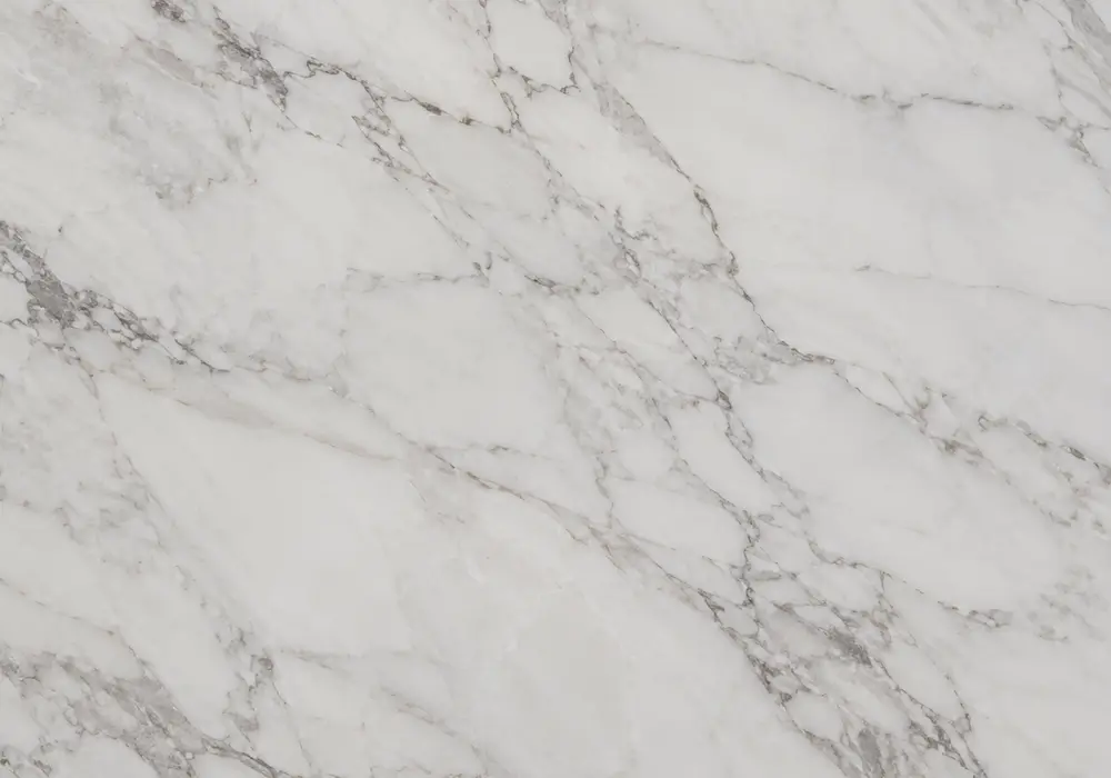 Crema Noble marble price in polished beige and cream stone with webbed veining and fossil details, across a luminous surface.