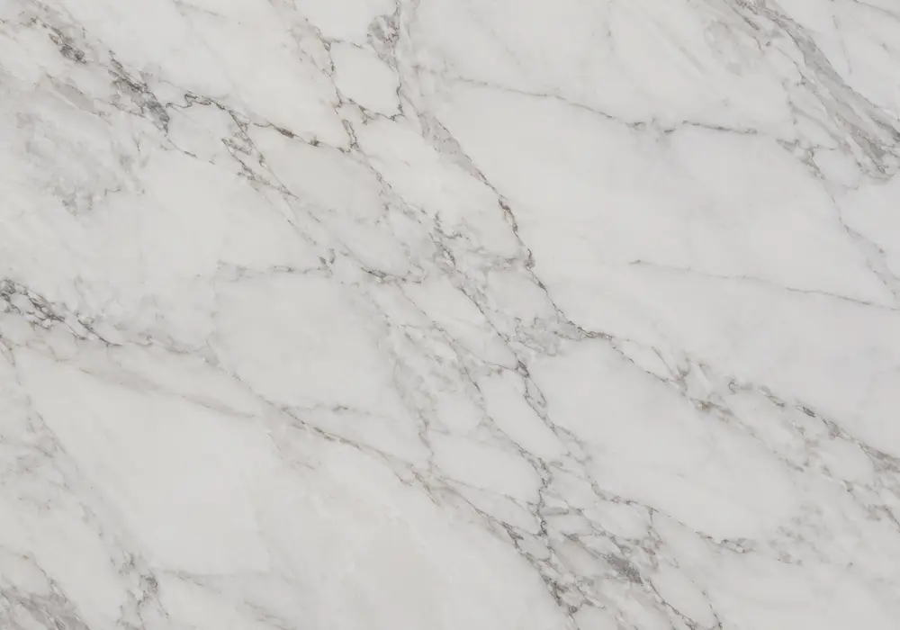 Dover White slabs with pearly ivory fields and fluid grey veins shown in polished, honed and leathered UAE showroom grades