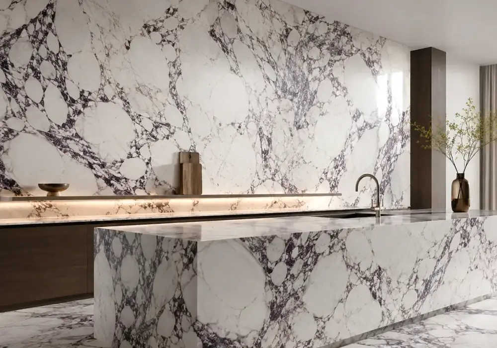 graceful blush vein texture used across a statement wall, flooring and an island countertop, with authentic slab variation.