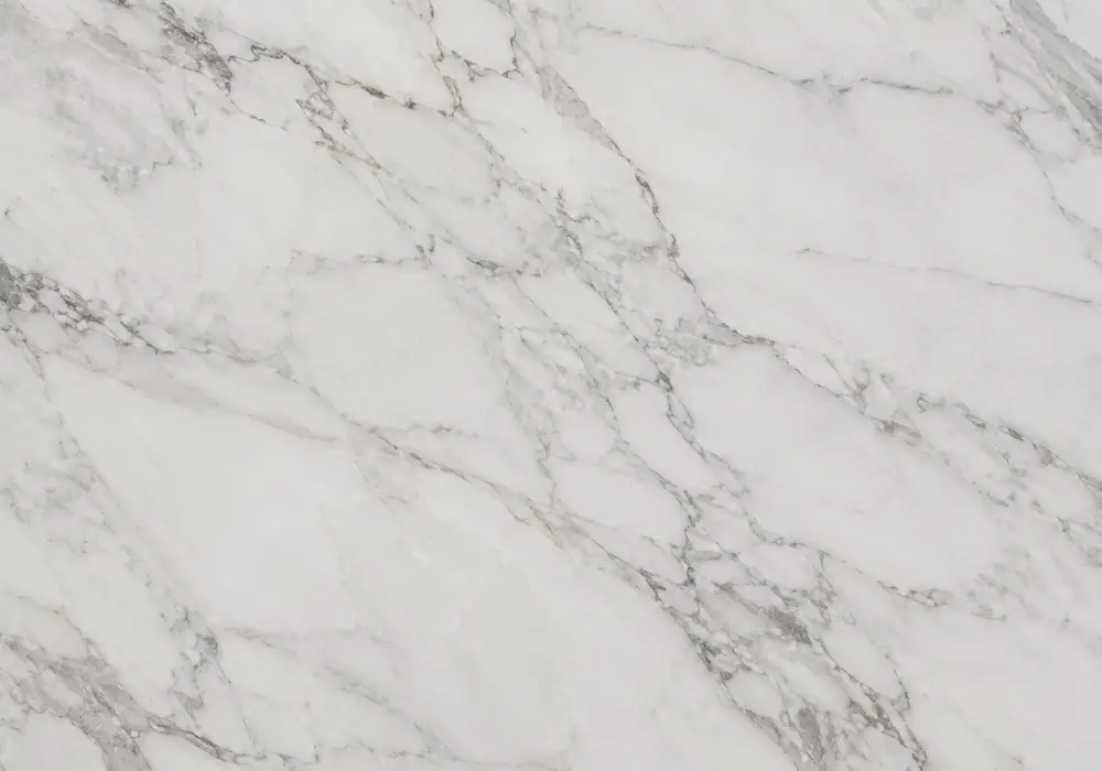 Greek Calacatta table cut from one white slab with grey, taupe and gold veins, shown beside polished and honed slab samples.