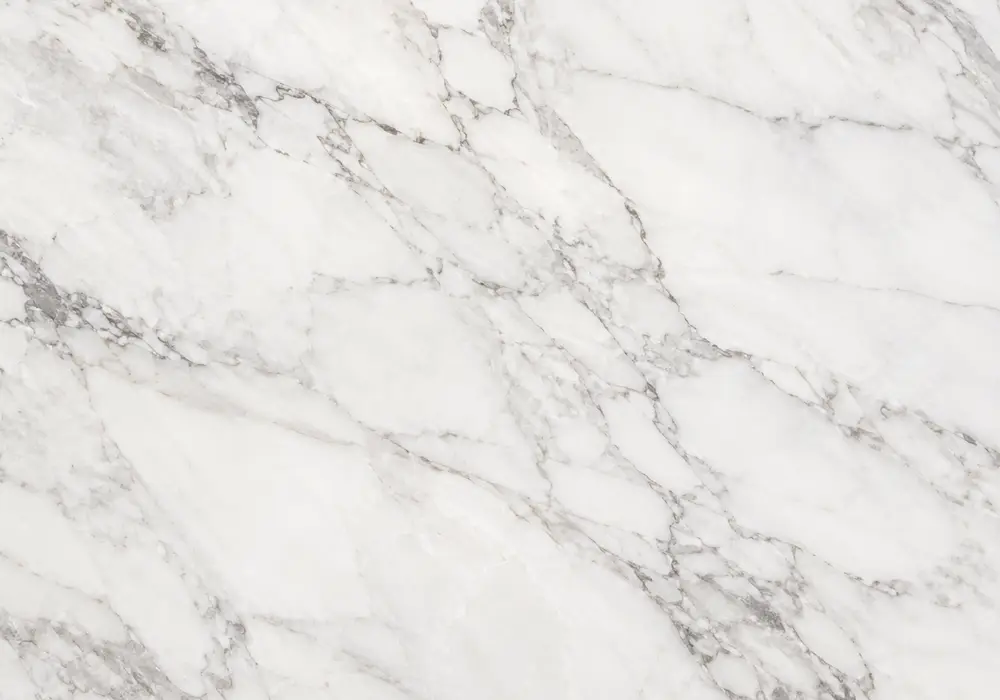 Layered Arabescato Orobico Grigio slab with sweeping grey, brown, cream and amber bands across a polished mineral surface.