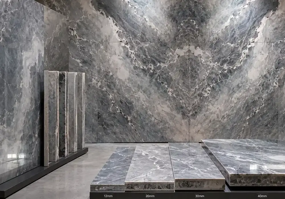 elegant cloud patterned stone used across a feature wall, flooring and an island countertop, with authentic slab variation.