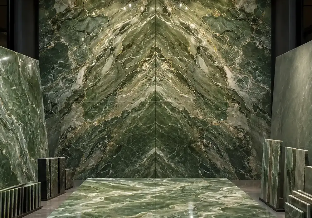 elegant deep green decorative stone across a statement wall, flooring and an island countertop, with natural slab variation.