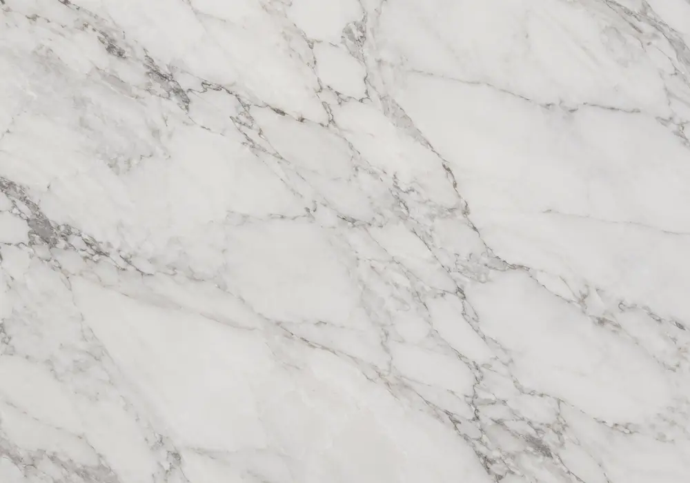 Statuario white marble slabs graded in a premium showroom with tile samples and export supports for UAE project selection.