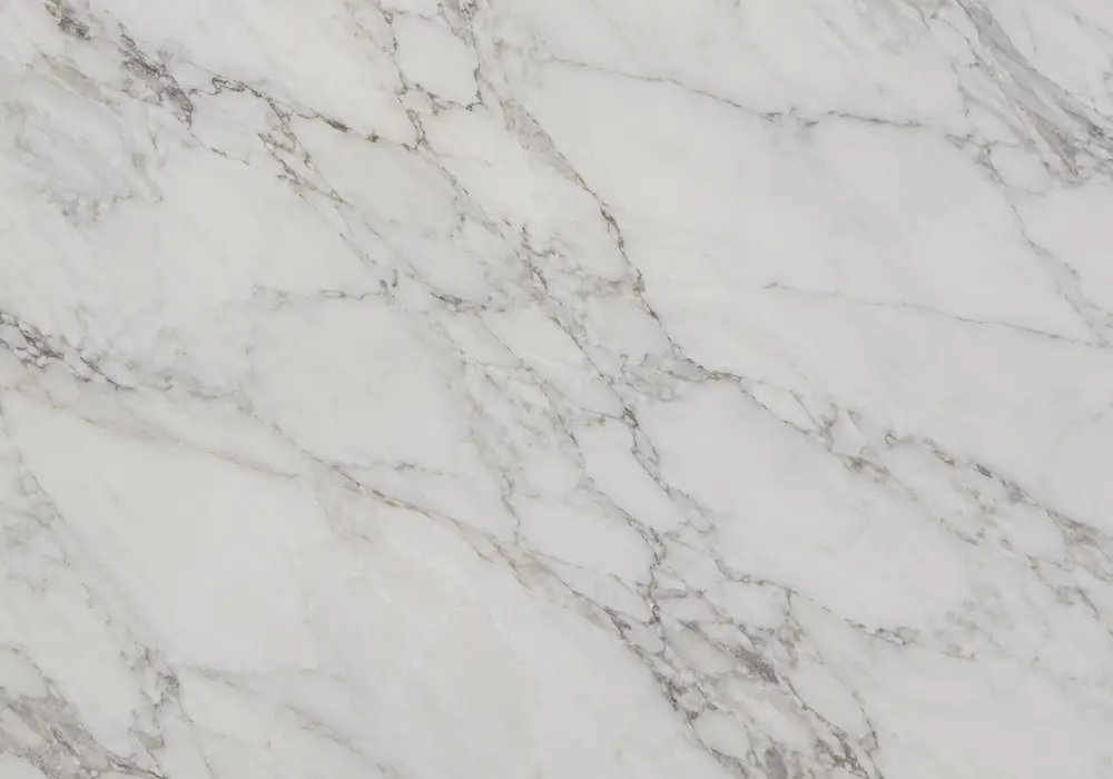 Elegant ivory space and controlled grey-gold movement express Carrara quarry heritage within a refined Italian marble slab.