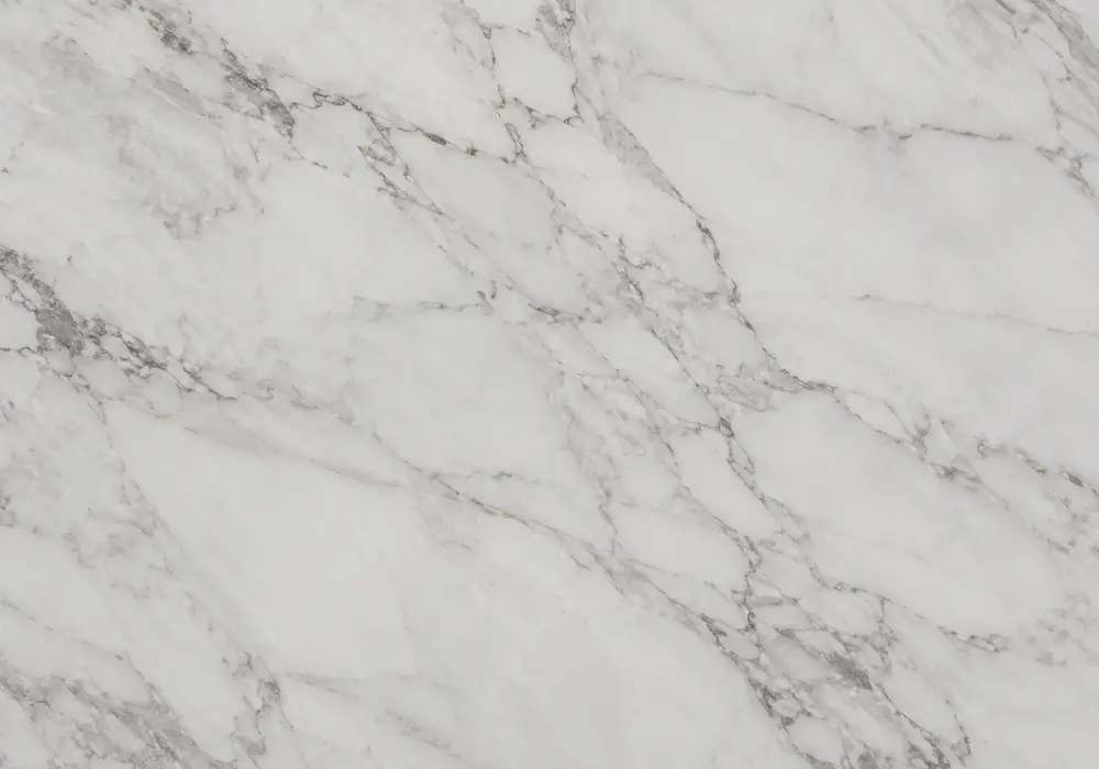 Warm light beige marble slab with ivory-sand tones, taupe hairlines, fossil traces, pale-gold bands and dusty-pink accents.