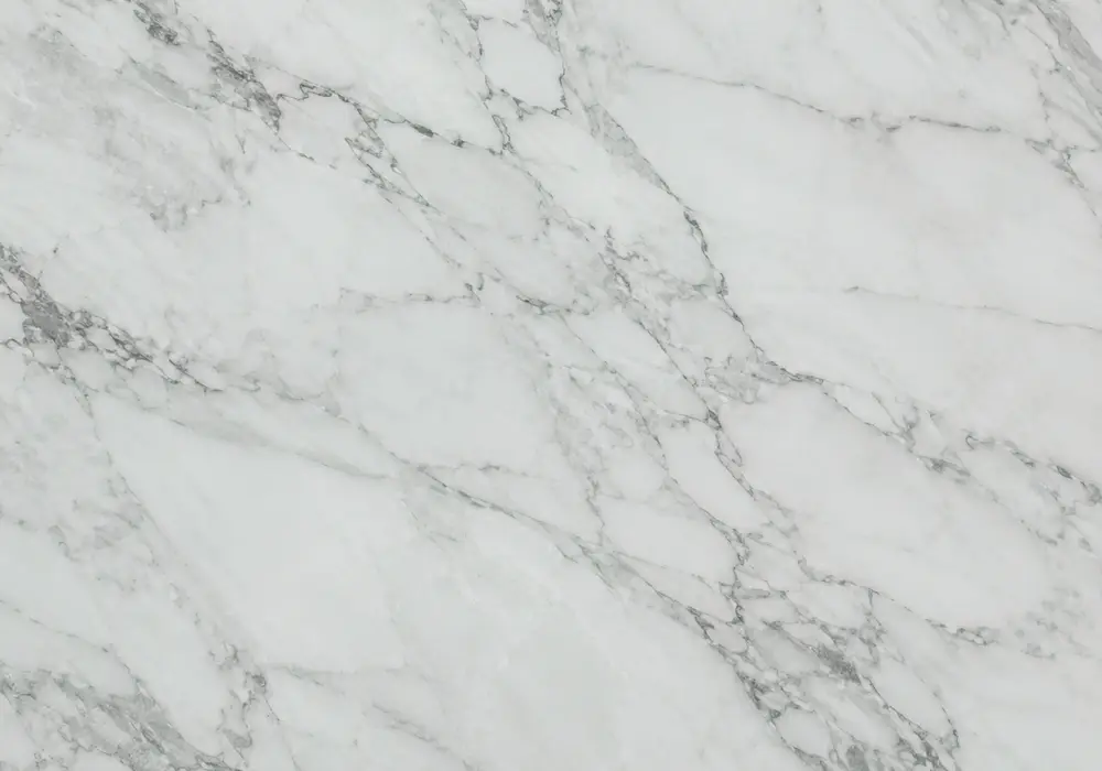 Soft pale green marble slab blending mint, sage and jade tones with delicate white ribbons, cloudy patches and fine fissures.