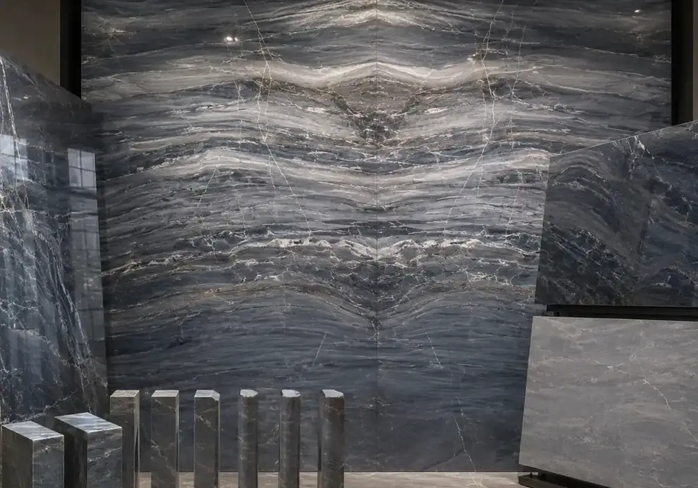 sophisticated textured feature stone across a feature wall, flooring and an island countertop, with authentic slab variation.