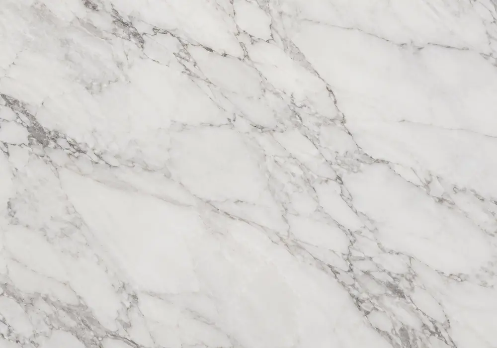 macchia vecchia porcelain beside polished waterfall island and bookmatched wall with irregular grey, amber and gold veins.