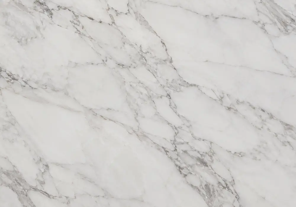 pure white Makrana slabs graded beside a polished carving, honed sample and edge offcut showing fine crystalline quality.