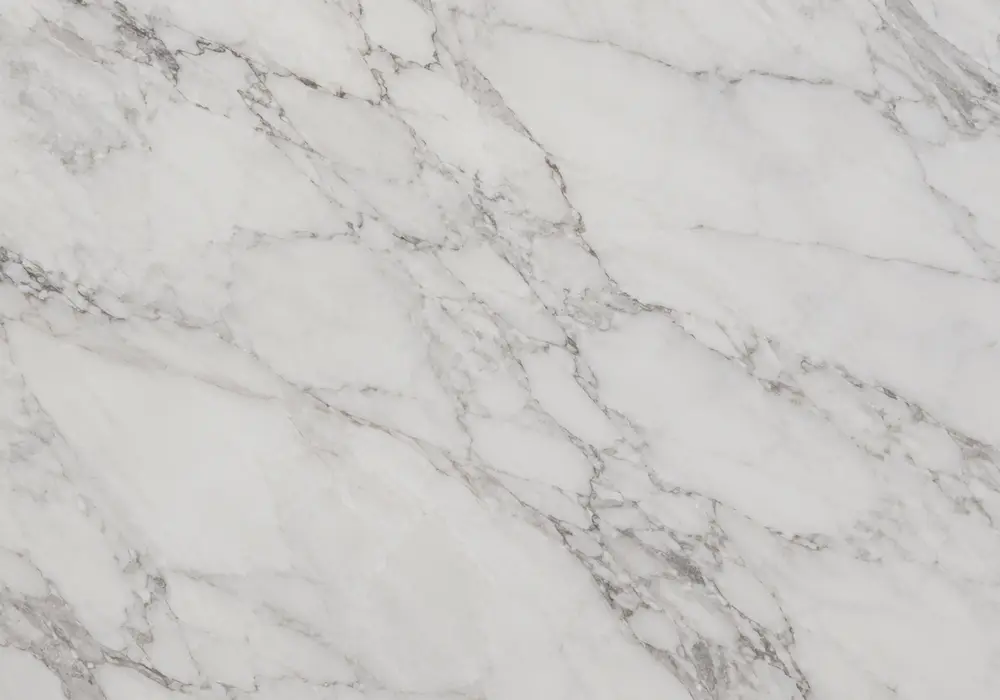 Makrana marble slabs in bright milky grades shown polished and honed beside tile samples, fabrication pieces and UAE stock