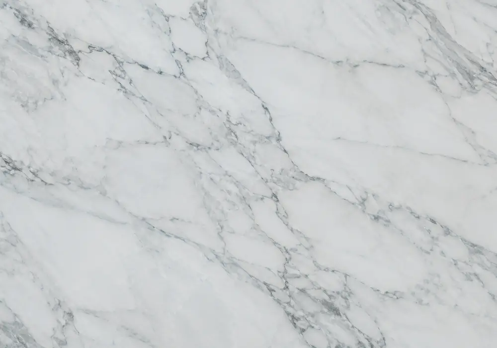 Layered blue marble slab with icy blue-grey, slate and navy tones, white ribbons, smoky shadows and translucent crystals.