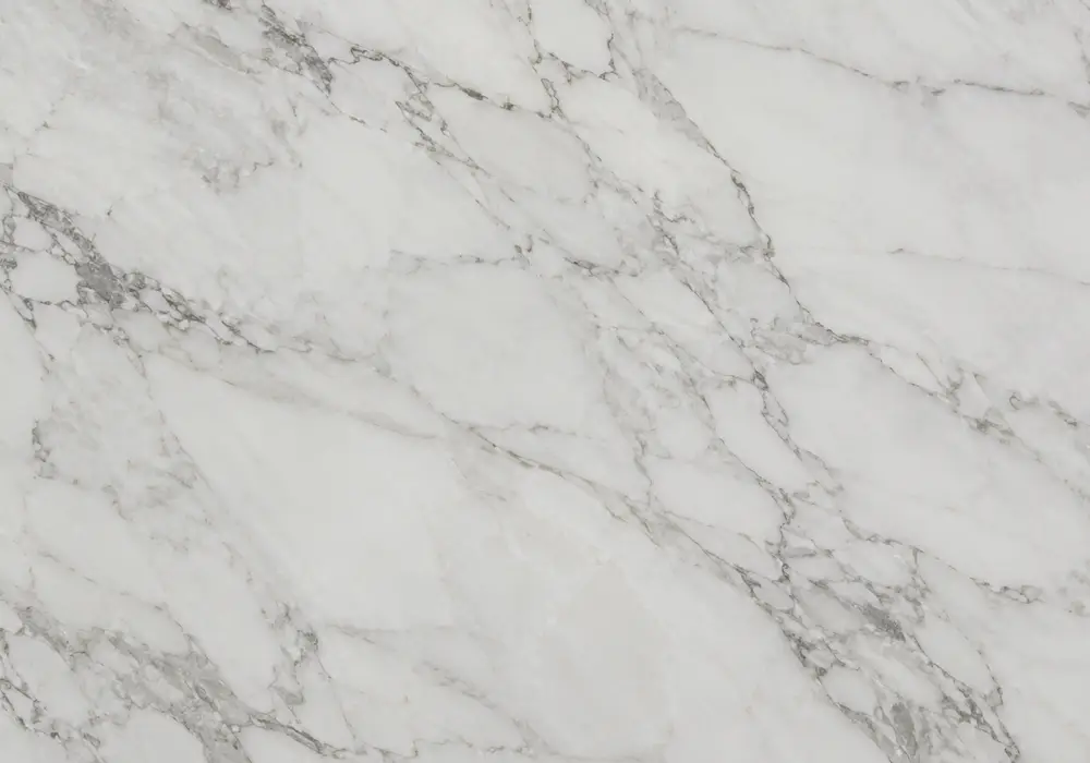 Calacatta Gold slabs displayed beside black-gold Portoro and yellow-gold stone with polished and honed colour slab variants.