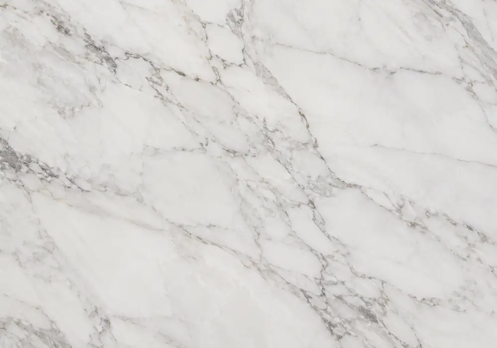 Michelangelo slabs in luminous white and ivory grades shown polished and honed with refined grey, taupe and gold veining