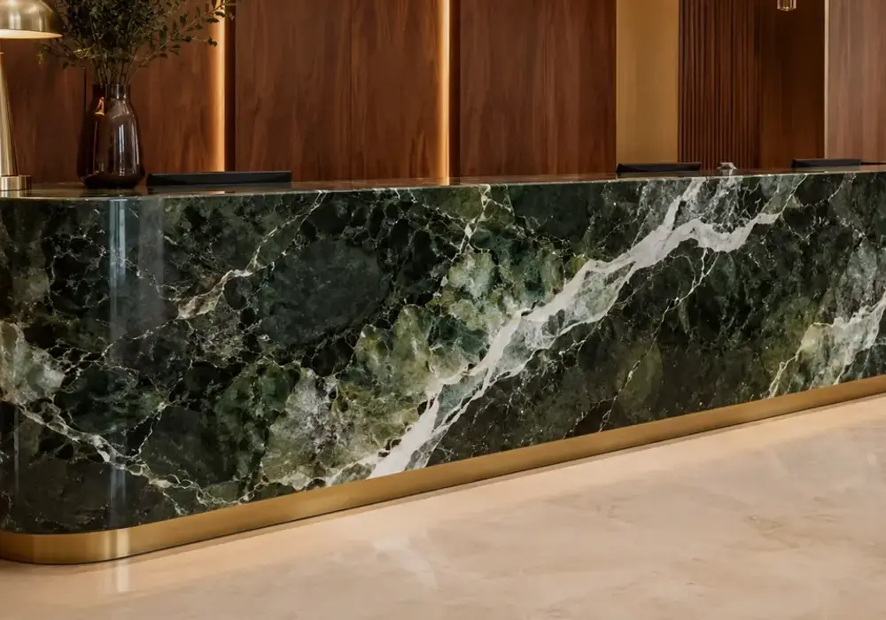 Mykonos Green marble statement fireplace with rich emerald-green stone and contrasting light mineral veins.