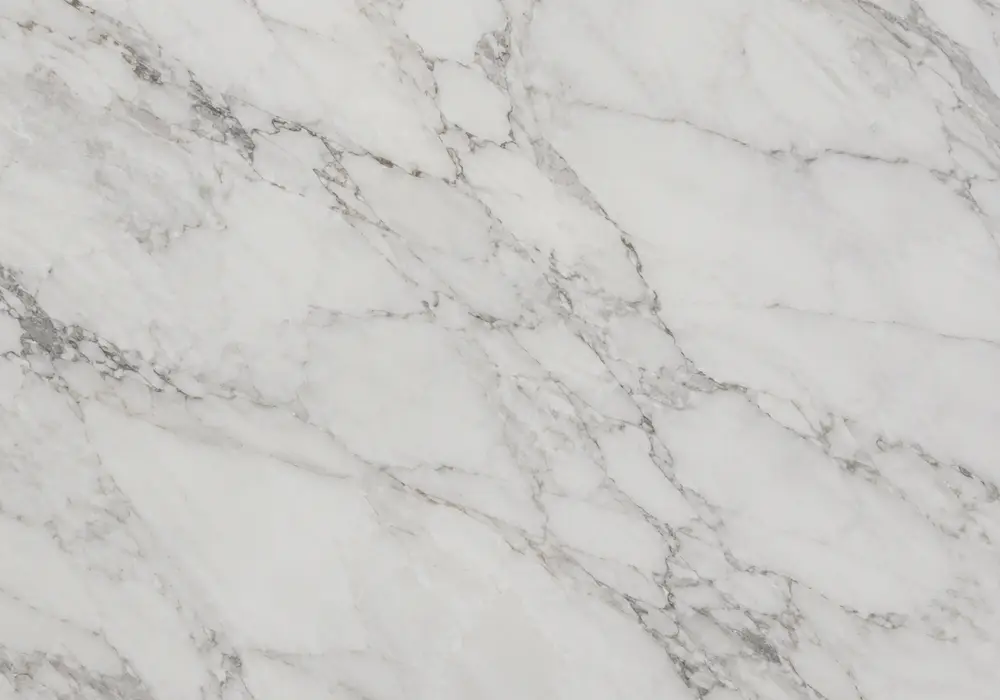 Nestos Beige vs Volakas on counter, vanity and hotel wall, comparing creamy directional veins with cleaner white Greek slab.