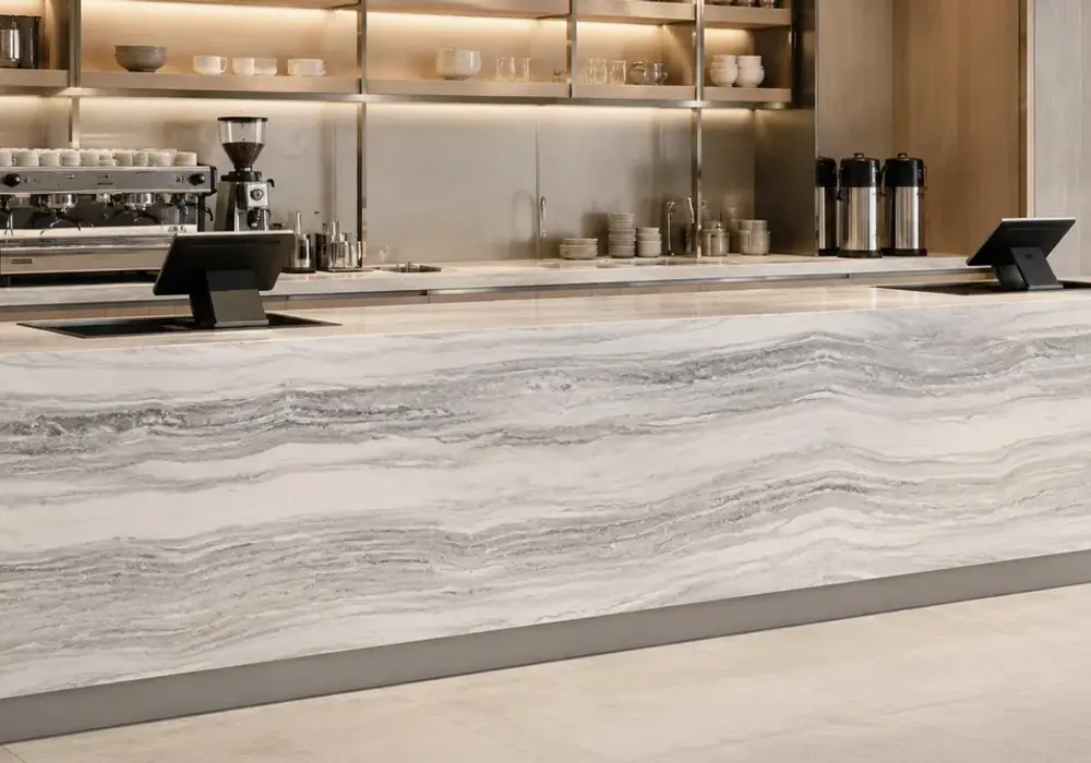 elegant neutral feature stone across wall cladding, large-format flooring and a countertop, with authentic slab variation.