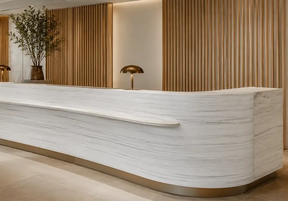 elegant contemporary feature stone across a feature wall, flooring and a sculptural countertop, with natural slab variation.