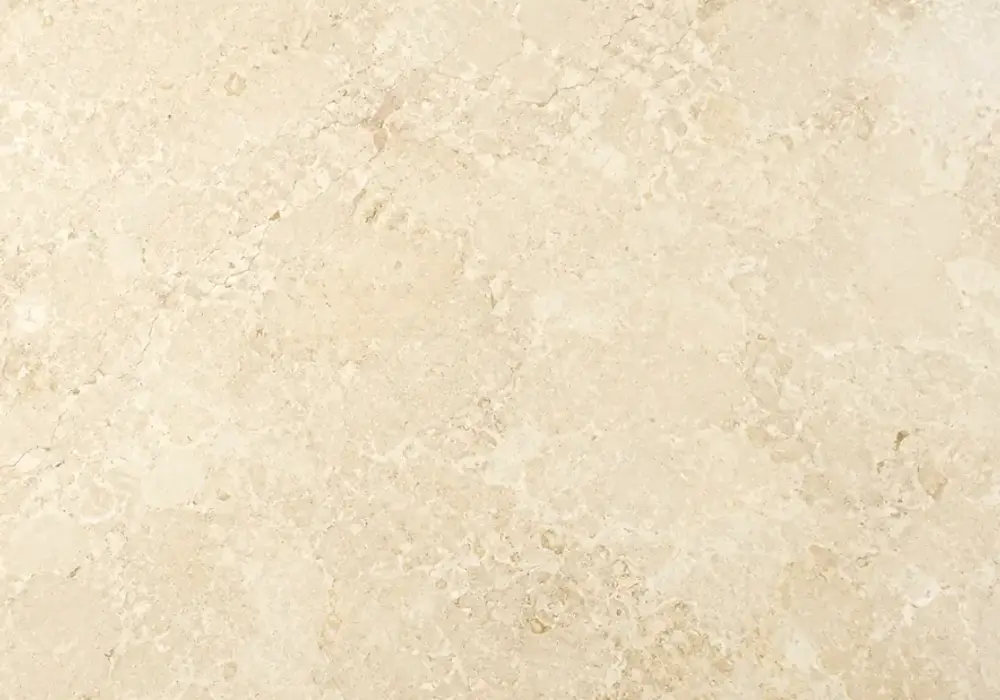 Omani Ivory Marble fireplace surround in a luxury stone showroom with upright slabs and refined wall finishes