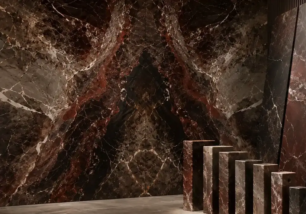 sophisticated feature stone across a statement wall, flooring and a sculptural countertop, with authentic slab variation.