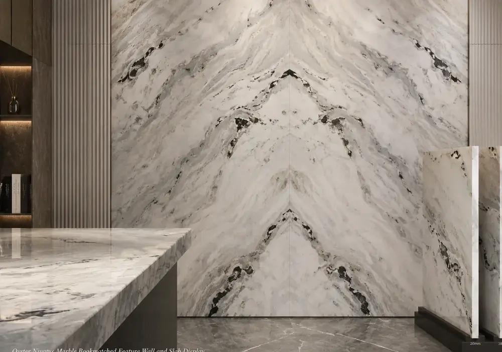 sophisticated bright feature stone across a feature wall, flooring and a sculptural countertop, with natural slab variation.