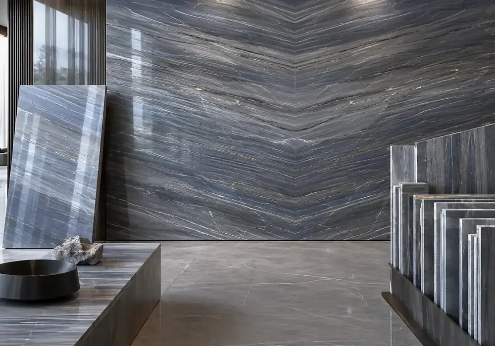 sophisticated feature stone across a statement wall, flooring and a sculptural countertop, with authentic slab variation.