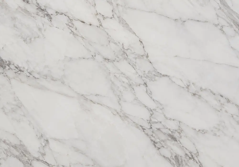 Perlato marble elegant dining tabletop with creamy beige stone, delicate gold-grey veining and fossil details.