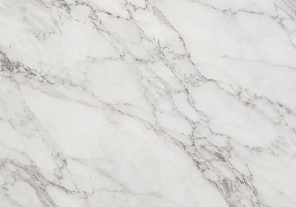 Picasso marble price reference showing an ivory slab with angular black-brown sketch lines, grey clouds and calm cream space.