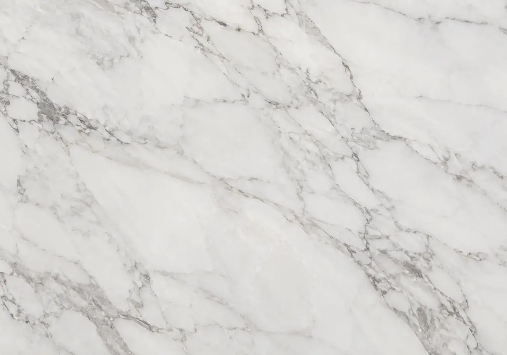 Large format marble tile on floors and walls with polished island, vanity, wet-area sample and precise slip-aware joints