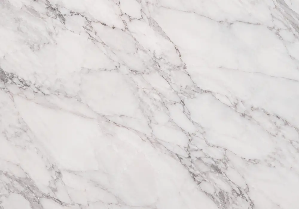 Pink Marble dining tabletop in a luxury stone gallery with upright slabs and refined architectural finishes
