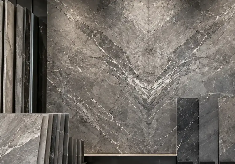 sophisticated modern feature stone across a feature wall, flooring and a sculptural countertop, with natural slab variation.