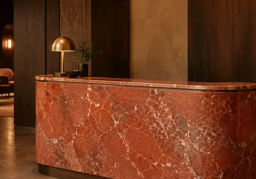 Murcia red marble in a Mediterranean hotel foyer, showing natural veining, natural stone depth and refined interior detail.